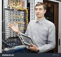 stock-photo-let-me-show-the-telecom-engineer-stand-in-data-center-and-show-telecommunication-equipment-128105342